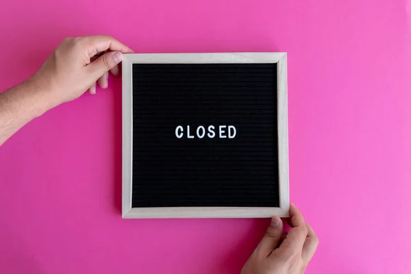 Man Hands Holding Small Black Board Closed Writing Pink Background — Stock Photo, Image