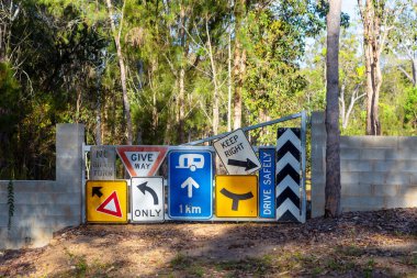 Random signs attached to a farm gate near Tinaroo Falls Dam in Queensland, Australia clipart