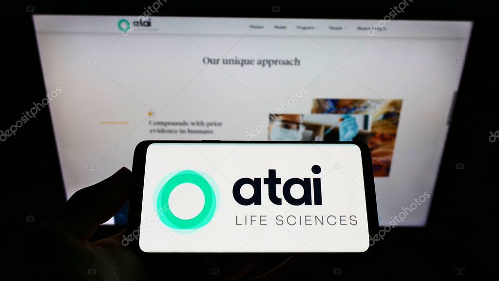 STUTTGART, GERMANY - Jun 14, 2021: Person holding cellphone with logo of German biotech company ATAI Life Sciences AG on screen in front of business web page. Focus on phone display.