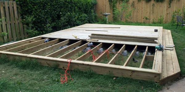 stock image Deck construction shows the deck with half covered decking and support beams underneath.