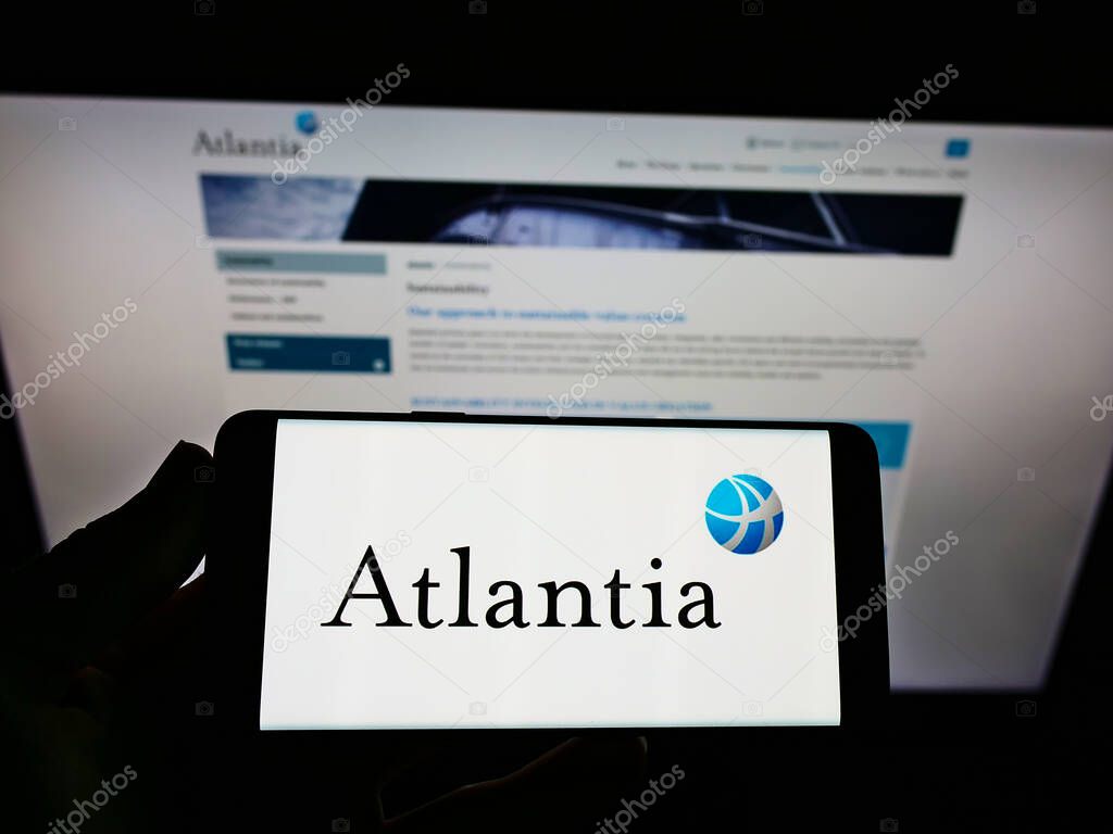 STUTTGART, GERMANY - May 30, 2021: Person holding smartphone with logo of Italian infrastructure company Atlantia SpA. on screen in front of business webpage. Focus on phone display.