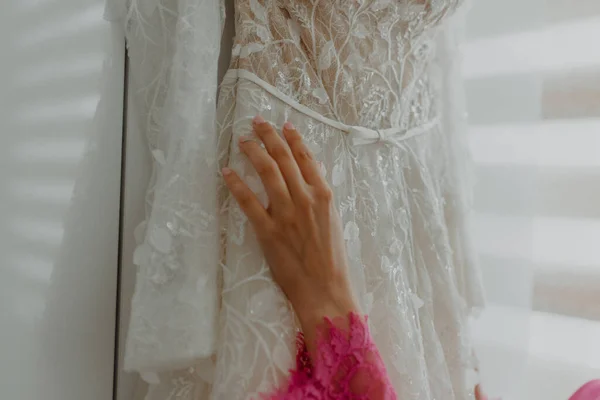 Рука Нареченої Торкається Повішеної Весільної Сукні — стокове фото