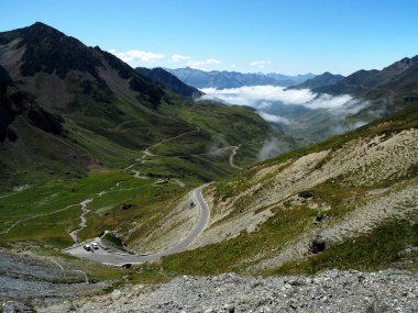 A shot of montane landscapes with narrow roads in Col du Tourmalet in Bagnerese-de-Bigorre, France clipart