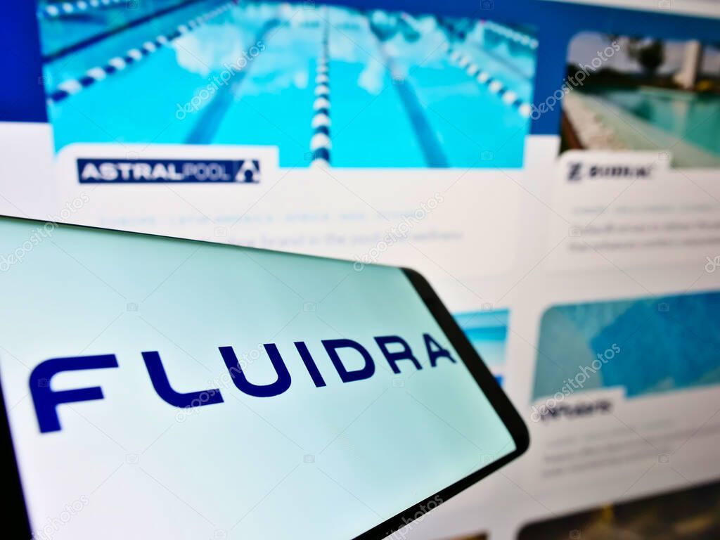 STUTTGART, GERMANY - Mar 13, 2021: Mobile phone with business logo of Spanish wellness equipment company Fluidra S.A. on screen in front of webpage. Focus on center of phone display.