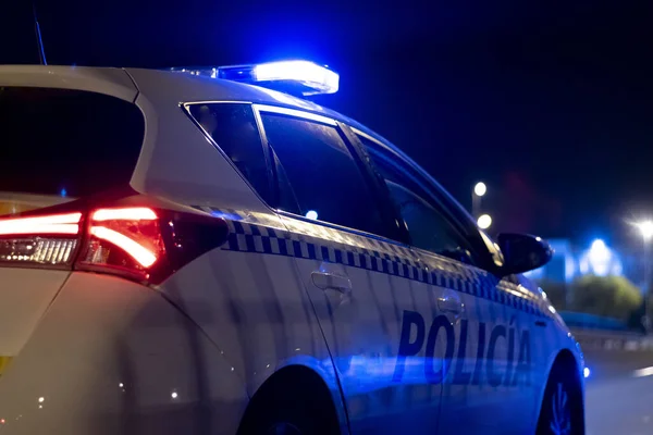A closeup shot of the police car on the street at night