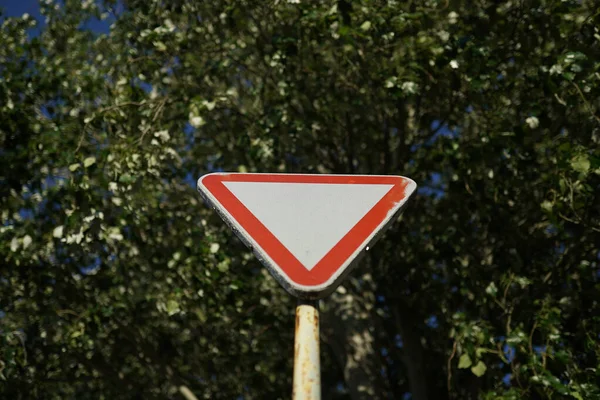 Triângulo Branco Aviso Sinal Estrada Contra Árvores — Fotografia de Stock