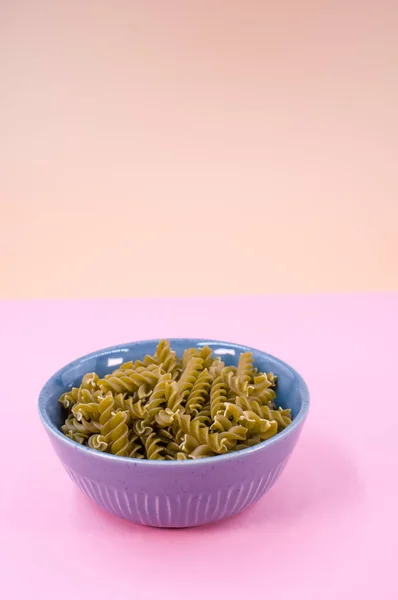 Vertical Shot Italian Fusilli Pasta Blue Bowl Pink Background Text — Stock Photo, Image