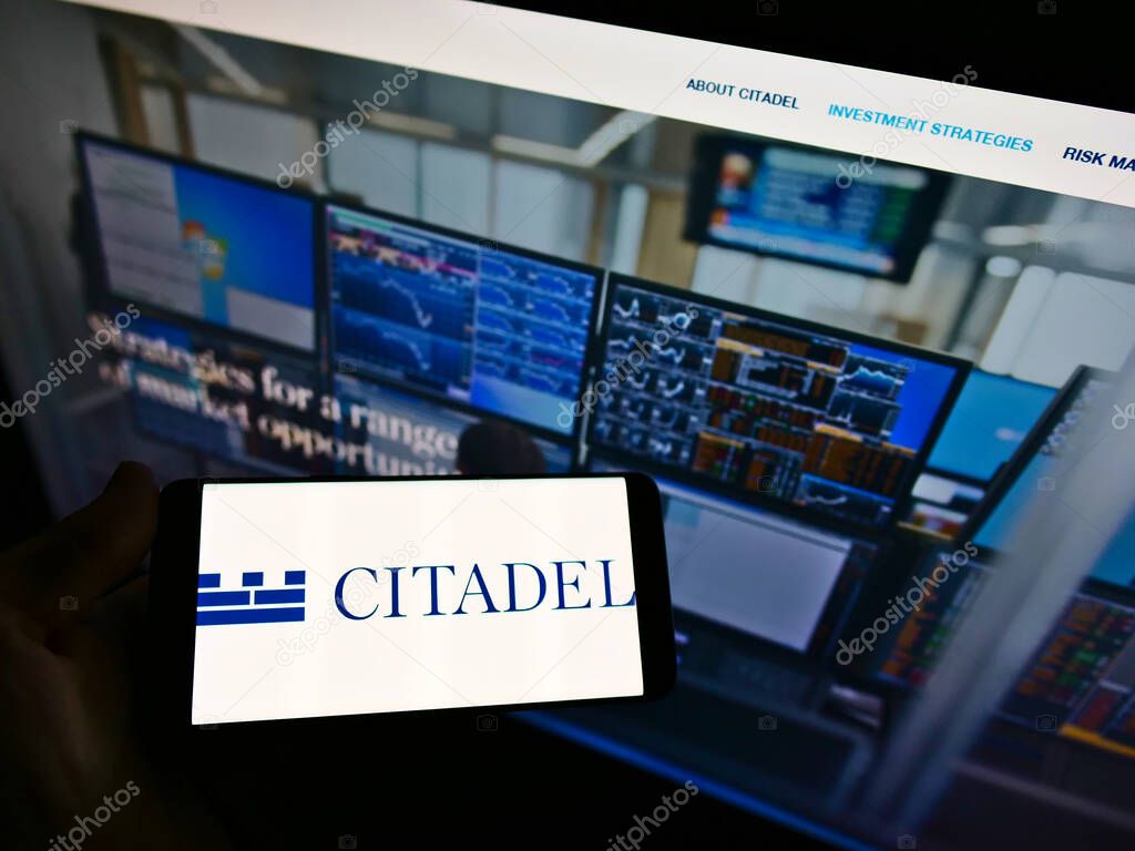 STUTTGART, GERMANY - Mar 03, 2021: Person holding smartphone with business logo of American investment company Citadel LLC on screen in front of web page. Focus on cellphone display.