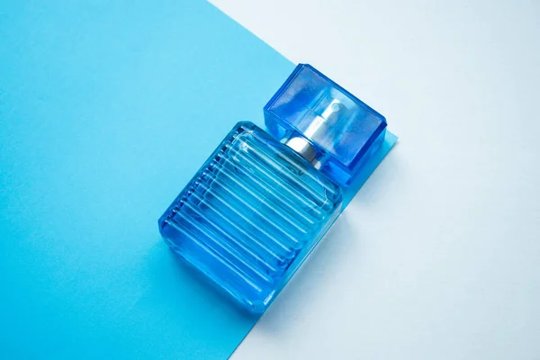 Egy Kék Parfümös Palack Közelsége Kék Fehér Alapon — Stock Fotó