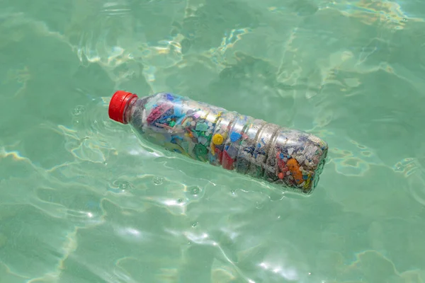 Bottle Filled Microplastics Lying Seawater — Stock Photo, Image