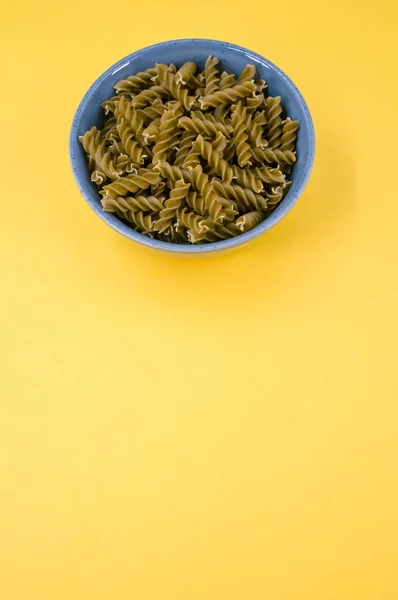 Vertical Shot Italian Fusilli Pasta Blue Bowl Yellow Background Text — Stock Photo, Image