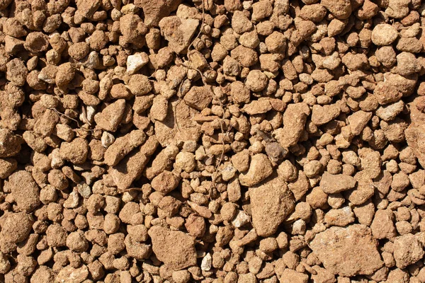 Tiro Perto Muitas Pedras Pequenas Chão Sob Sol Quente — Fotografia de Stock