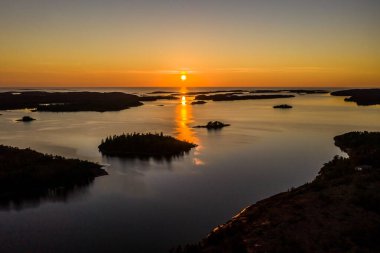 Aerial view of silhouette islands of Geta in Aland, serene, summer sunset, in Finland clipart