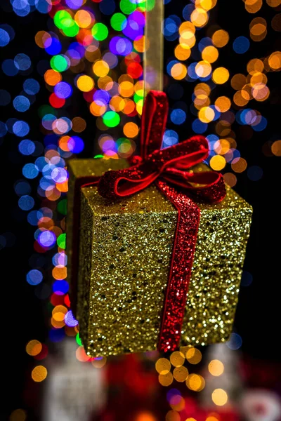 Vertical Shot Hanging Glittered Gift Box Ornament Colorful Bokeh Background — Stock Photo, Image