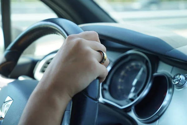 stock image LISBON, PORTUGAL - Aug 28, 2021: A selective focus shot of a female's hand with a ring driving a car in Lisbon, Portugal