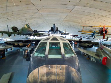 Planes hang from the ceiling in Duxford Air museum hangar clipart