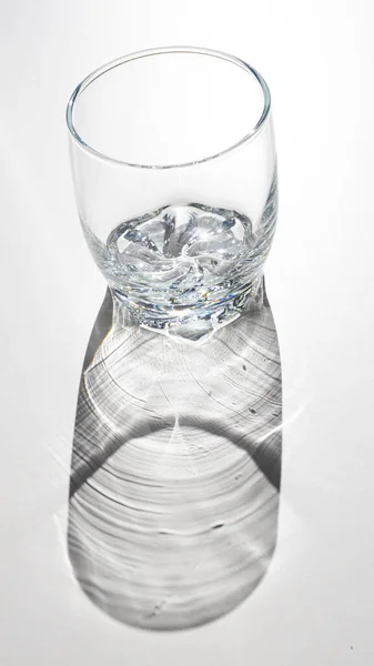 Vertical Closeup Empty Glass White Surface — Stock Photo, Image