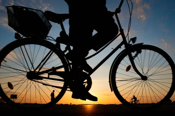 Una Silueta Pueblo Bicicleta Durante Una Puesta Sol Naranja — Foto de Stock