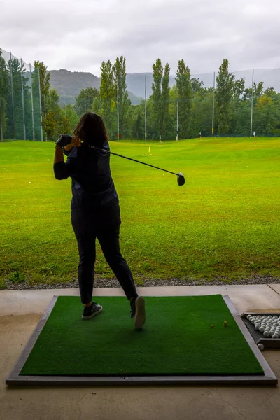 Golfer Training Her Golf Club Driver on Driving Range in Switzerland.