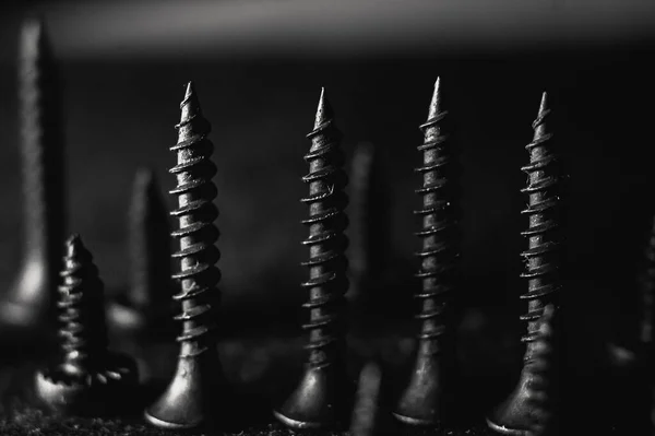 Grayscale Shot Pile Bolts Nuts Dark Blurred Background — Stock Photo, Image