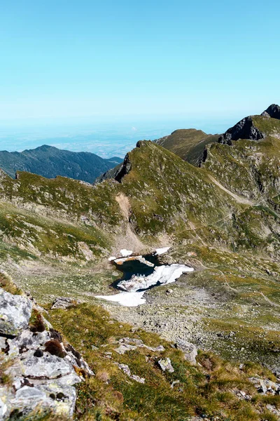 Sebuah Gunung Berbatu Ditutupi Dengan Rumput Dan Salju Mencair Terhadap — Stok Foto