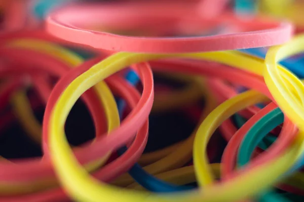 A closeup blurry shot of colorful elastic rubber bands