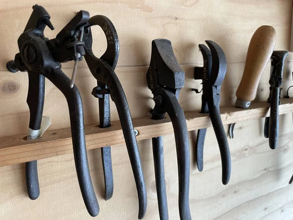 Closeup Sharp Black Metal Tools Hanging Wooden Shelf — Stock Photo, Image