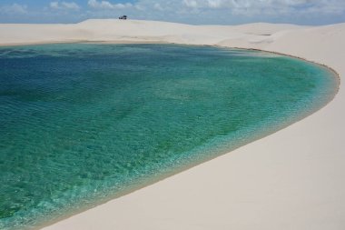 A beautiful shot of white sand dunes and clear lagoon in Lencois Maranhenses National park in Brazil clipart