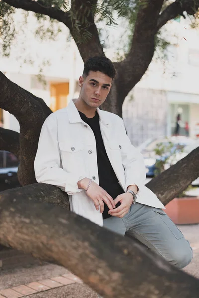 Vertical Shot Young Stylish Caucasian Man White Jacket Leaning Tree — стоковое фото