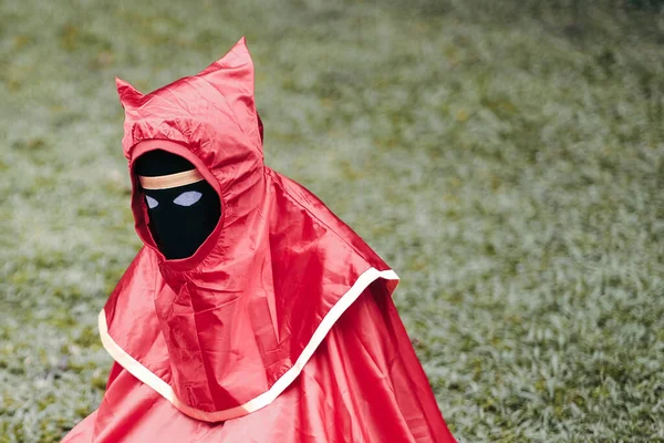 Une Personne Portant Imperméable Rouge Masque Noir Couvrant Son Visage — Photo