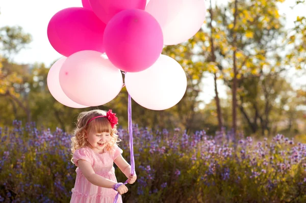 Baby girl with pink balloons — Stock Photo, Image