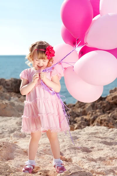 Baby girl with pink balloons — Stock Photo, Image