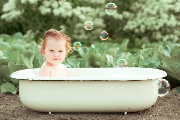 Baby girl washing in bath outdoor — Stock Photo, Image