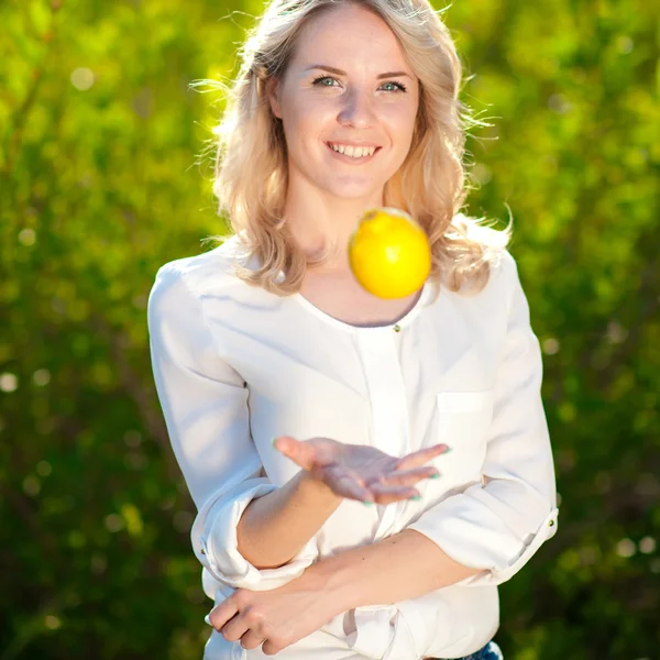 Beautiful blond woman with lemon — Stock Photo, Image