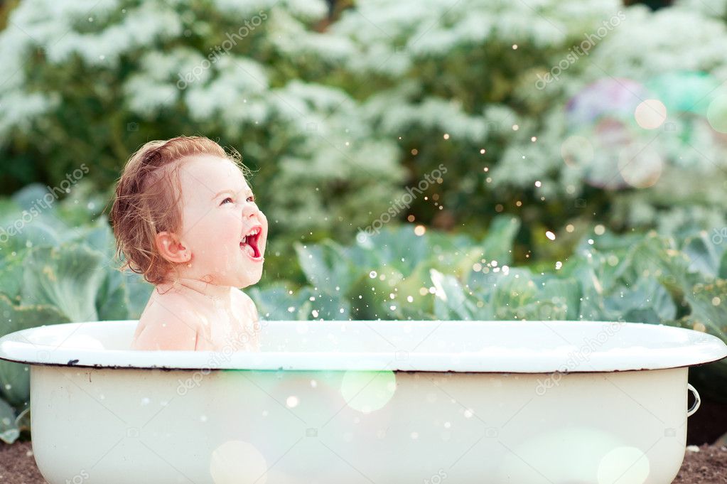 baby girl washing in bath outdoor