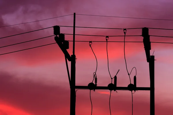 Electrical post with power line cables against sunset — Stock Photo, Image