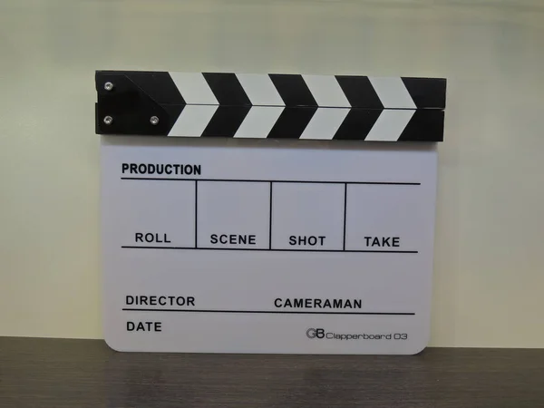 Clapperboard black-white, glossy macro. Cinematic equipment. The background. For the audio track.
