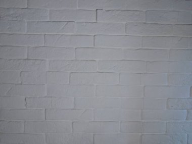 Beyaz tuğla ve desen gölgelerinden yapılmış doku duvarı. Lambanın ışığı. Arkaplan.