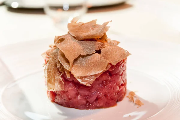 Alba white truffle sliced on raw minced meat from Piedmontese Fassona breed cattle