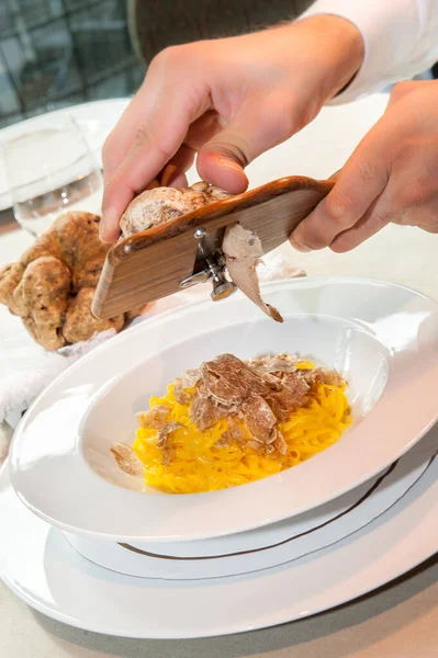 serve the white truffle from Alba in Italy with a slicer on a plate of tagliolini-spaghetti with egg