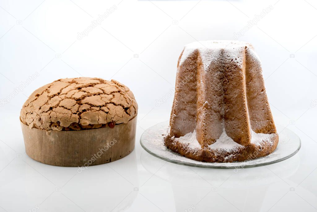 Panettone  and Pandoro, with icing sugar,  traditional Italian Christmas  cakes isolated on white background