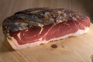 Speck, tipik Güney Tyrol füme jambonu, İtalya 'da Alto Adige - ahşap kesim tahtasında çiğ domuz eti