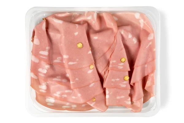 Slices of Bologna mortadella sausage with pistachio  in plastic tray for sale in supermarket, top view flat lay