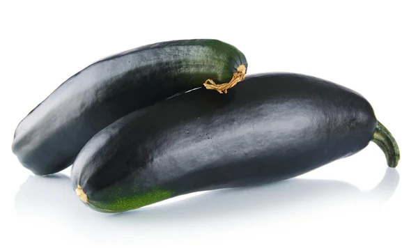 Black courgettes on white background — Stock Photo, Image