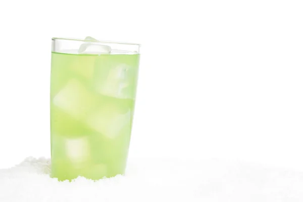 Glass of lime juice with ice cubes on snow on white — Stock Photo, Image