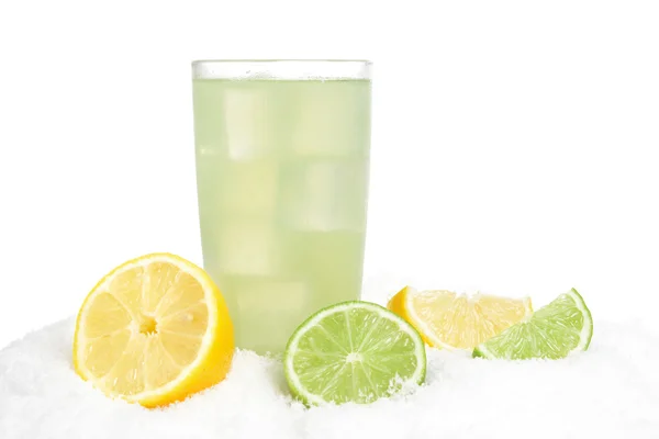 Glass of lime juice with ice cubes,limes and lemons halves on snow on white — Stock Photo, Image