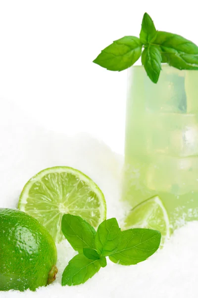 Cropped image-glass of lime juice with ice cubes on snow on white — Stock Photo, Image