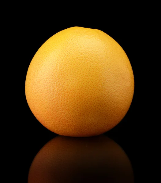 Single grapefruit isolated on black background — Stock Photo, Image