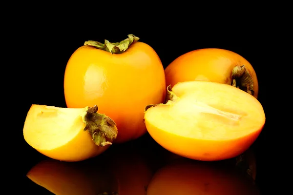 Studio shot many kakis sliced isolated black — Stock Photo, Image