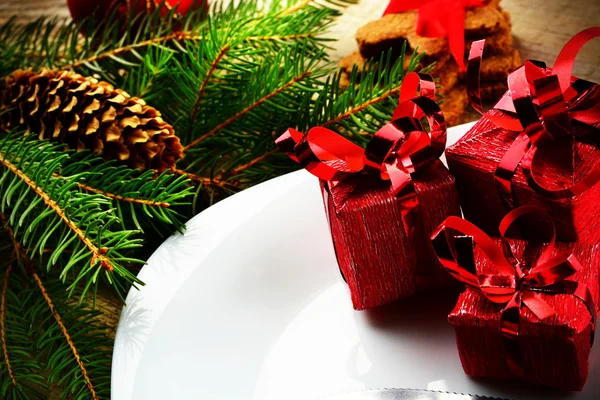 Крупный план Рождественская тарелка красные подарки сосны деревянная поверхность — стоковое фото